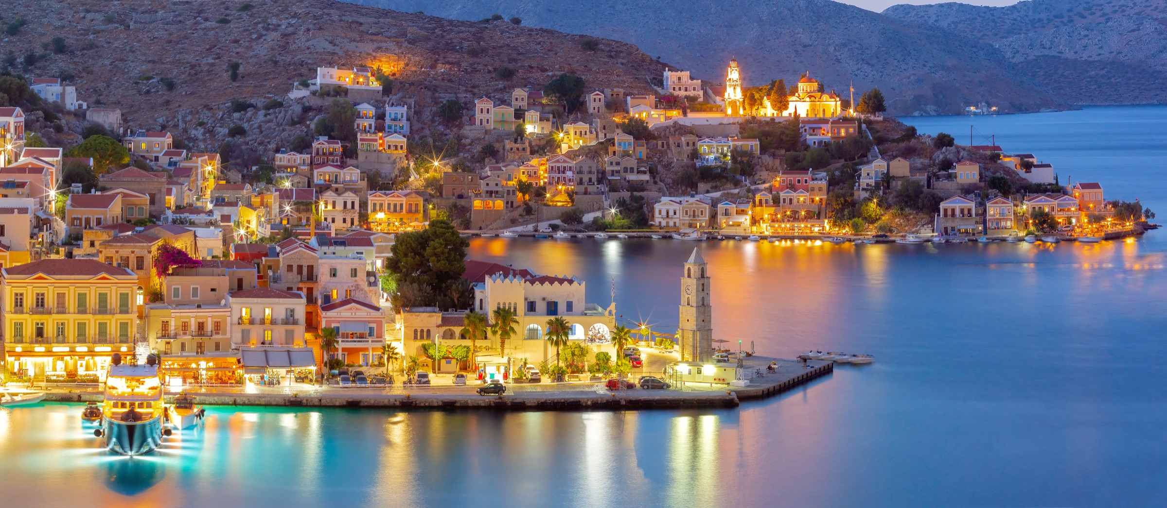 Symi harbour glowing at night
